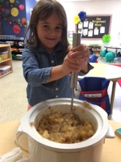 Livvy mashes apples.jpg